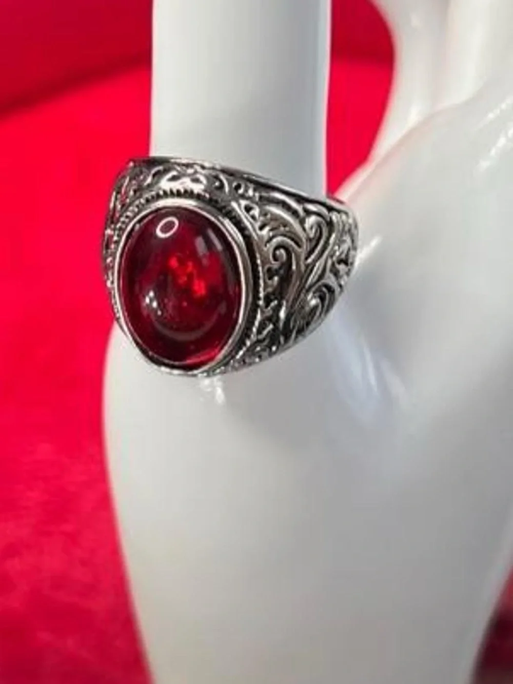 Red ruby gemstone ring with silver filigree detailing